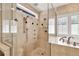 Luxurious bathroom featuring a glass enclosed shower with multiple shower heads and a soaking tub at 137 Spring Chase Cir, Altamonte Springs, FL 32714