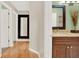 Bathroom featuring double sink vanity, hardwood floors, with connecting hallways at 137 Spring Chase Cir, Altamonte Springs, FL 32714