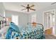 Bright bedroom featuring a bed, ceiling fan, window with shutters and ensuite bathroom at 137 Spring Chase Cir, Altamonte Springs, FL 32714