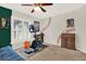 A carpeted bedroom featuring fitness equipment, a ceiling fan, natural light and baseball themed wall art at 137 Spring Chase Cir, Altamonte Springs, FL 32714