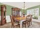 Traditional dining room featuring green walls, vintage furniture, and natural light from a window at 137 Spring Chase Cir, Altamonte Springs, FL 32714