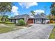 Long driveway leading to the exterior featuring a two-car garage, solar panels and ample parking space at 137 Spring Chase Cir, Altamonte Springs, FL 32714