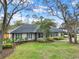 An inviting home showcases mature landscaping and a well manicured lawn at 137 Spring Chase Cir, Altamonte Springs, FL 32714