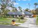 Single-story home with solar panels, a well-kept lawn, and a whimsical mailbox at 137 Spring Chase Cir, Altamonte Springs, FL 32714