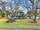 Landscaped front yard showing mature trees, green lawn, and charming exterior of the single-story home at 137 Spring Chase Cir, Altamonte Springs, FL 32714