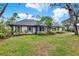 Well-maintained front yard showcasing a neutral home with dark trim and a dark roofline at 137 Spring Chase Cir, Altamonte Springs, FL 32714