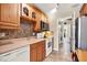 Kitchen with wood cabinets, tile backsplash, and white appliances at 137 Spring Chase Cir, Altamonte Springs, FL 32714