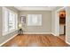 Well-lit living room with hardwood floors, plantation shutters, and a doorway leading to the kitchen at 137 Spring Chase Cir, Altamonte Springs, FL 32714