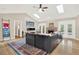 Bright living room with hardwood floors, a fireplace, skylights, and French doors leading to the pool at 137 Spring Chase Cir, Altamonte Springs, FL 32714