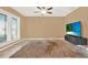 Cozy living room with a ceiling fan, tiled floors, and a large window with plantation shutters at 137 Spring Chase Cir, Altamonte Springs, FL 32714