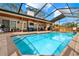 Inviting screened-in pool featuring brick surround, an outdoor kitchen, and a covered patio seating area at 137 Spring Chase Cir, Altamonte Springs, FL 32714