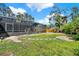 The screen enclosed pool highlights the luscious landscaping of the backyard at 137 Spring Chase Cir, Altamonte Springs, FL 32714