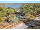 Scenic aerial view of the tennis court surrounded by mature trees and overlooking a serene lake at 137 Spring Chase Cir, Altamonte Springs, FL 32714