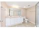 Bathroom featuring double sinks, a large mirror, and a glass-enclosed shower at 145 N Pearl Lake Cswy # 104, Altamonte Springs, FL 32714