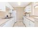 Well-lit kitchen featuring white appliances and cabinets, designed for functionality at 145 N Pearl Lake Cswy # 104, Altamonte Springs, FL 32714