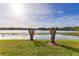 Scenic water view from lawn showcasing lily pads and a sunny sky at 145 N Pearl Lake Cswy # 104, Altamonte Springs, FL 32714