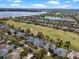 Beautiful aerial view of neighborhood homes, golf course, and a lake in a sunny day at 15144 Spinnaker Cove Ln, Winter Garden, FL 34787