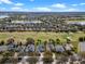 Aerial view of the house surrounded by a golf course, neighborhood homes and a lake at 15144 Spinnaker Cove Ln, Winter Garden, FL 34787