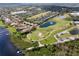 Beautiful aerial view of a golf course and a lake surrounded by neighborhood homes at 15144 Spinnaker Cove Ln, Winter Garden, FL 34787