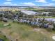 Aerial view of a neighborhood bordering a golf course and a lake with water features at 15144 Spinnaker Cove Ln, Winter Garden, FL 34787