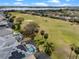 Gorgeous aerial view showcasing the home's proximity to the golf course, lake, screened-in pool, and solar panels at 15144 Spinnaker Cove Ln, Winter Garden, FL 34787