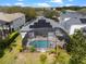 Overhead view of a home with a screened-in pool, solar panels, and lush landscaping providing a private backyard oasis at 15144 Spinnaker Cove Ln, Winter Garden, FL 34787