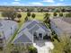 Aerial view of a well-maintained home with solar panels, beautiful landscaping, and an inviting front porch and driveway at 15144 Spinnaker Cove Ln, Winter Garden, FL 34787