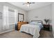 Bedroom featuring a bed, dresser, ceiling fan, and a window with blinds at 15144 Spinnaker Cove Ln, Winter Garden, FL 34787