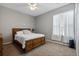 Bedroom featuring a bed, nightstand, and a window with curtains at 15144 Spinnaker Cove Ln, Winter Garden, FL 34787