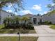 Charming single-story home featuring a well-manicured lawn and inviting curb appeal with palm trees at 15144 Spinnaker Cove Ln, Winter Garden, FL 34787