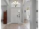 Inviting foyer with a chandelier, sidelight windows, and decorative tile flooring at 15144 Spinnaker Cove Ln, Winter Garden, FL 34787