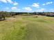 The green golf course has a clear blue sky with trees near the well-maintained grass at 15144 Spinnaker Cove Ln, Winter Garden, FL 34787