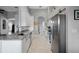 Bright kitchen featuring stainless steel appliances, white cabinets, and a tile floor at 15144 Spinnaker Cove Ln, Winter Garden, FL 34787