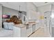 An open concept kitchen featuring white cabinets and a marble countertop island at 15144 Spinnaker Cove Ln, Winter Garden, FL 34787