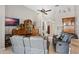 Comfortable living room features tile floors, ceiling fan, and gray leather sofas at 15144 Spinnaker Cove Ln, Winter Garden, FL 34787