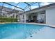 Beautiful view of an in-ground pool from the patio, featuring a pool with blue tile accents at 15144 Spinnaker Cove Ln, Winter Garden, FL 34787