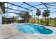 Screened-in pool area showcasing clear blue water and tropical landscaping at 15144 Spinnaker Cove Ln, Winter Garden, FL 34787