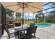 Outdoor dining area next to the pool, perfect for enjoying meals in the open air at 15144 Spinnaker Cove Ln, Winter Garden, FL 34787