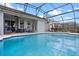 The beautiful screened pool offers a perfect view to the rear patio and seating at 15144 Spinnaker Cove Ln, Winter Garden, FL 34787