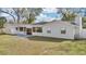 Back exterior view featuring a newly installed stone patio and a large yard, ideal for entertaining guests at 1536 Errol Pkwy, Apopka, FL 32712