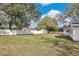 Expansive backyard with lush grass, large trees, and a white fence at 1536 Errol Pkwy, Apopka, FL 32712