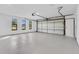 Spacious garage featuring three windows and an insulated garage door at 1536 Errol Pkwy, Apopka, FL 32712