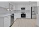 Bright kitchen with white cabinets, stainless steel appliances, quartz countertops and a window with a view at 1536 Errol Pkwy, Apopka, FL 32712