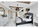 Comfortable main bedroom featuring wood beam accents, a decorative lamp, and stylish decor at 15919 Winding Bluff Dr, Montverde, FL 34756