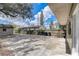 A view of the backyard with mature trees, a concrete patio, and lawn at 1707 Wilton Ave, Orlando, FL 32805