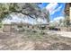 A view of the spacious backyard with mature trees, patio furniture, and well-maintained lawn at 1707 Wilton Ave, Orlando, FL 32805