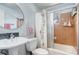 This bathroom has a sleek vanity, a shower/tub combo with a floral shower curtain and good lighting at 1707 Wilton Ave, Orlando, FL 32805