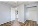 A light and airy bedroom featuring modern wood-look floors, closet and views into the kitchen at 1707 Wilton Ave, Orlando, FL 32805