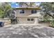 Two-story home exterior with private entrance, concrete parking pad and a metal staircase at 1707 Wilton Ave, Orlando, FL 32805