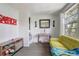 Bright living room with a small table and a comfortable yellow sofa at 1707 Wilton Ave, Orlando, FL 32805